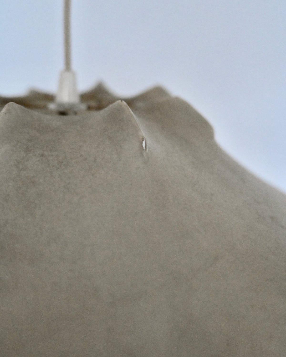 Close-up of small tear on vintage Cocoon shade
